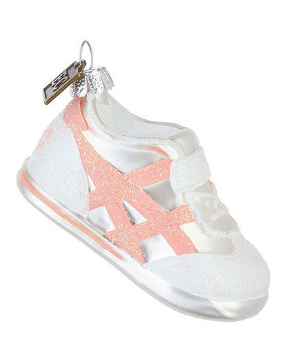 White sneaker with pink star design on a white background