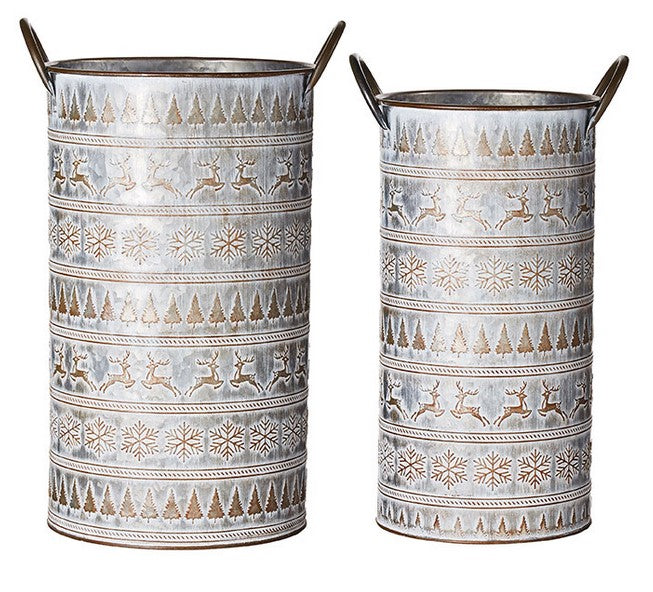 Two cylindrical metal vases with winter-themed patterns on a white background