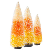 Three candy corn-themed Christmas trees on a white background