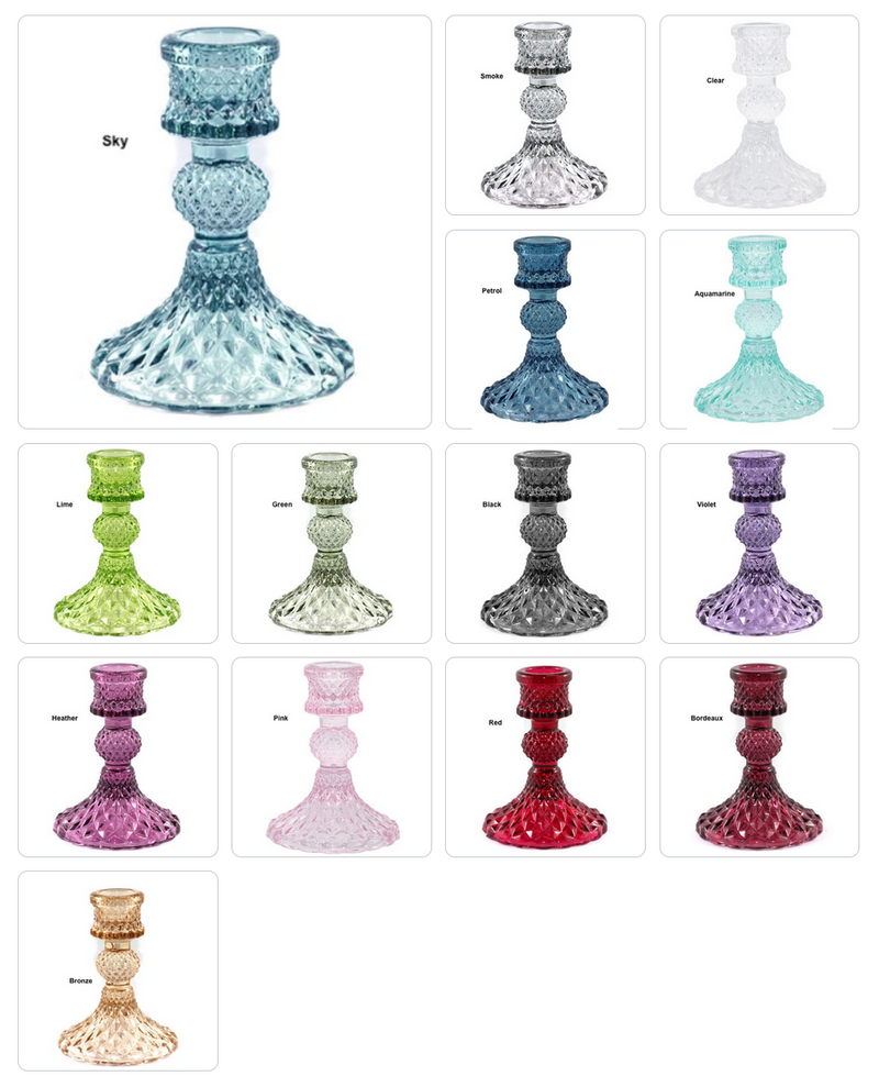 Collection of colorful glass candle holders in various designs on a white background.