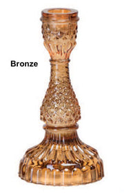 A collection of Bella Candle Holders in various colors. These vintage-inspired glass holders have a pressed and lacquered design, standing 4 inches wide by 8.