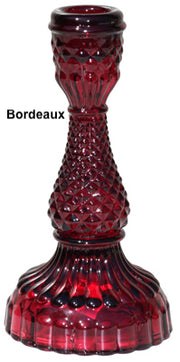 A collection of Bella Candle Holders in various colors. These vintage-inspired glass holders have a pressed and lacquered design, standing 4 inches wide by 8.
