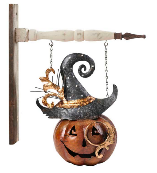 Decorative Halloween pumpkin with a witch hat and broomstick on a white background