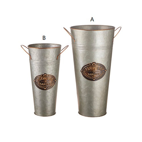 Two galvanized grey metal handled flower buckets, one larger and one smaller, with a decorative label on each.