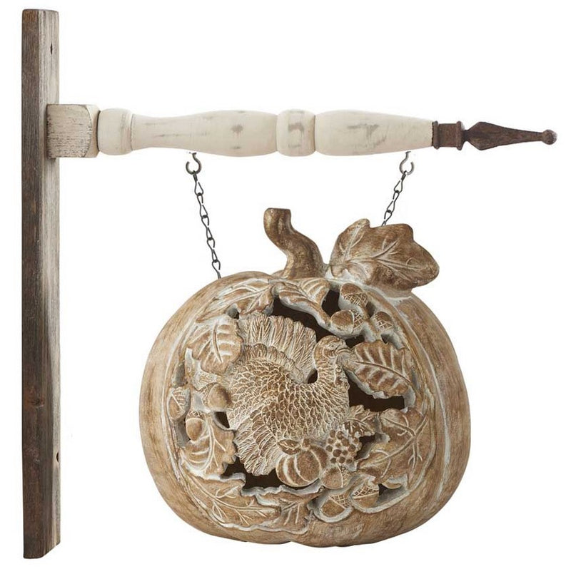 Decorative wall hanging with floral design and wooden handle on a white background
