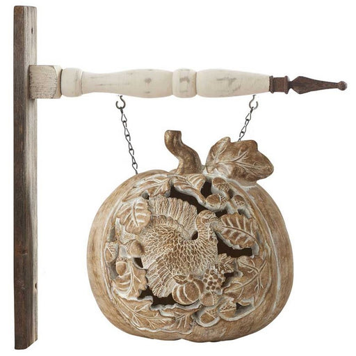 Decorative wall hanging with floral design and wooden handle on a white background