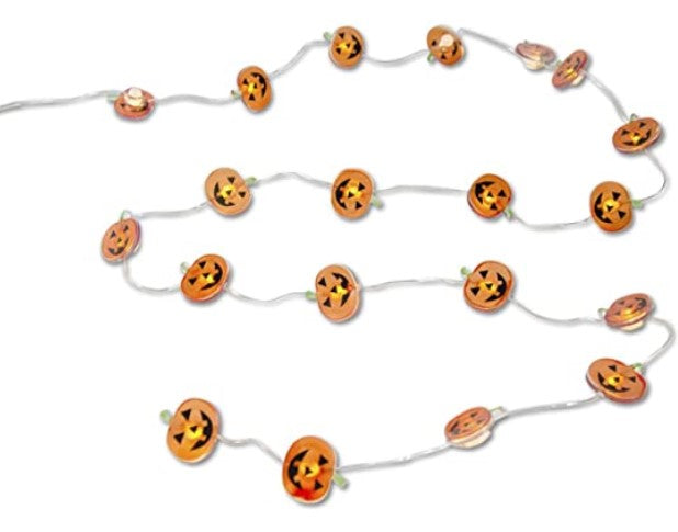 String of small pumpkin lights on a white background