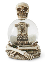 Decorative item with skull, crossbones, and 'RIP' tombstone inside a glass sphere on a white background