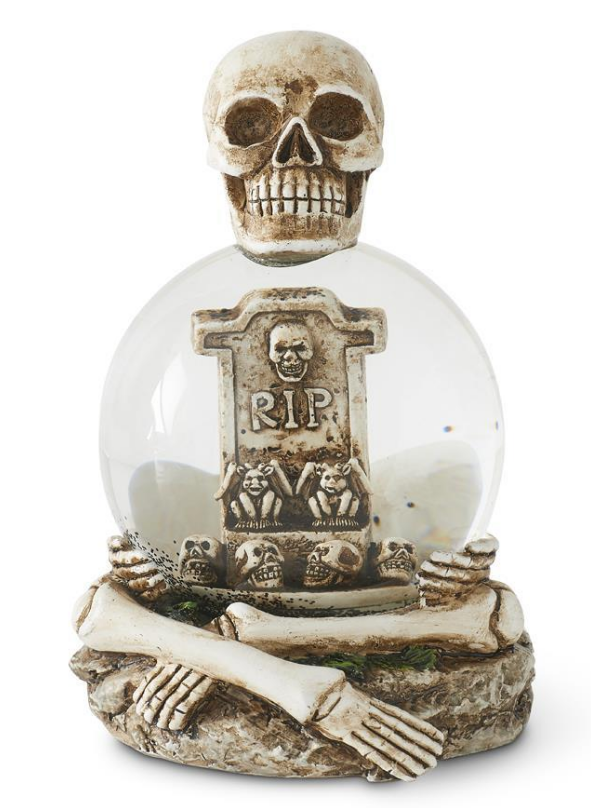 Decorative item with skull, crossbones, and 'RIP' tombstone inside a glass sphere on a white background