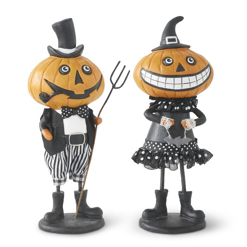 Two Halloween-themed pumpkin figurines, one dressed as a gentleman and the other as a lady, on a white background.