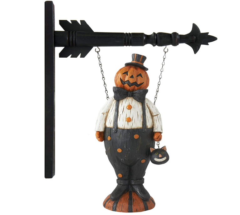 Halloween-themed decorative figure hanging on a black arrow-shaped wall hook.