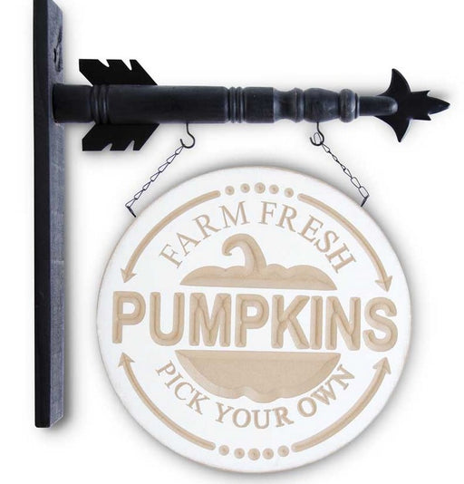 Round wooden sign with 'Farm Fresh Pumpkins Pick Your Own' text and an arrow on a white background