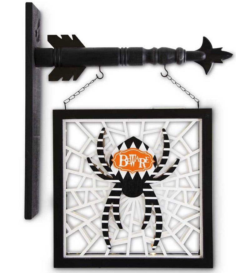 Decorative Halloween sign with spider design and 'B&V' logo on a white background