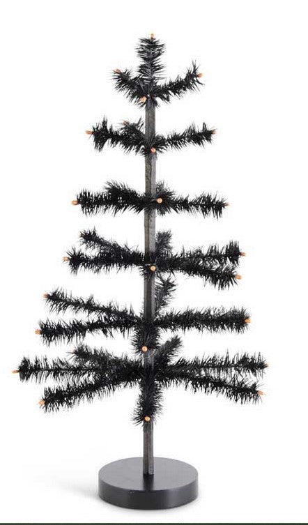 Black artificial Christmas tree with lights on a white background
