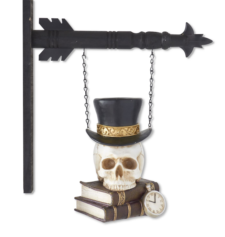 Decorative skull hanging on an arrow shaped hook