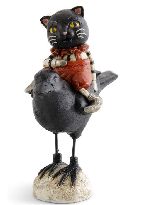 Cat figurine sitting on a bird with a white background