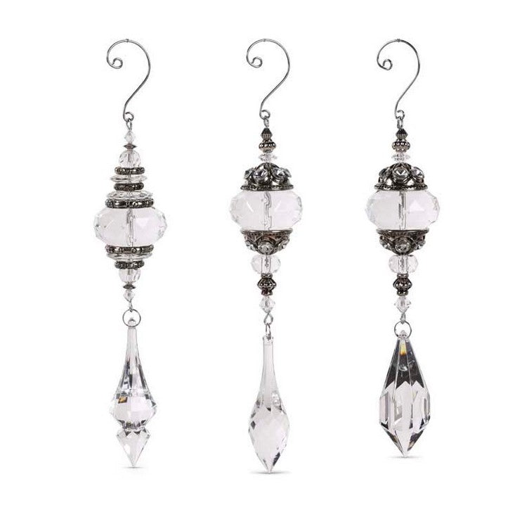 Set of three crystal earrings with silver accents on a white background