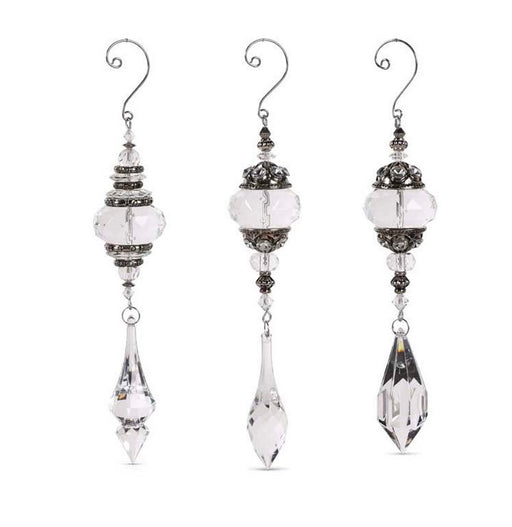 Set of three crystal earrings with silver accents on a white background