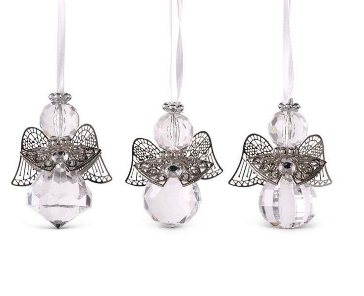 Three angel-shaped ornaments with crystal bodies on a white background