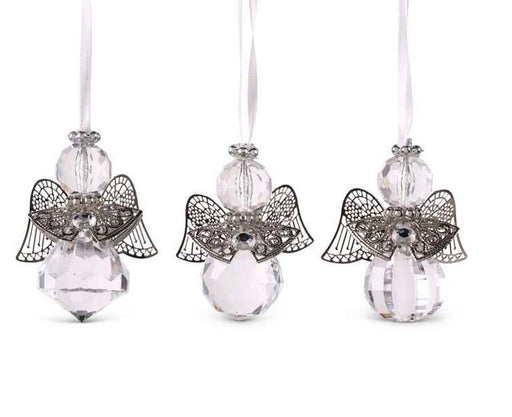 Three angel-shaped ornaments with crystal bodies on a white background