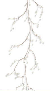 Decorative branch with small white flowers on a white background