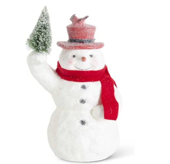 Snowman figurine with a red scarf and hat holding a small tree on a white background