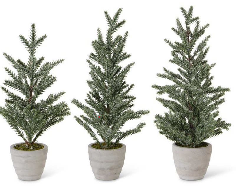 Three potted artificial Christmas trees on a white background