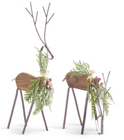 Decorative deer figurines with foliage on a white background