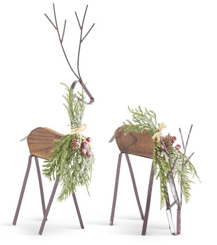 Decorative deer figurines with foliage on a white background