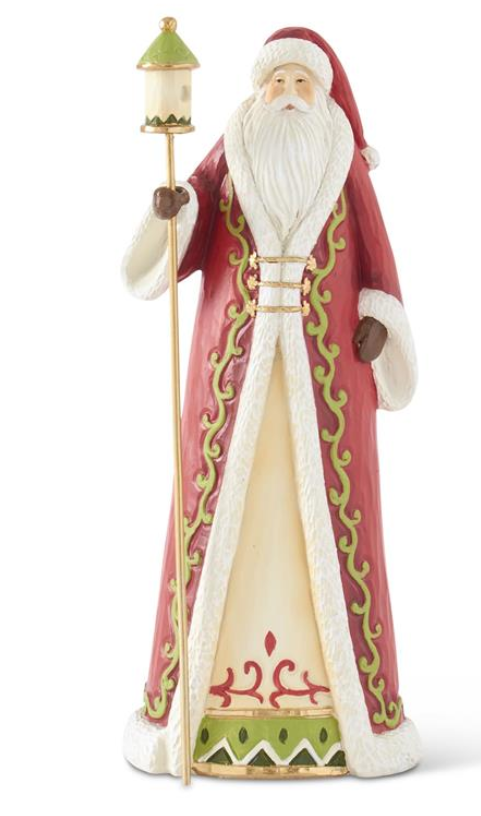 Decorative figurine of a character in a red and white robe with green accents, holding a lantern.
