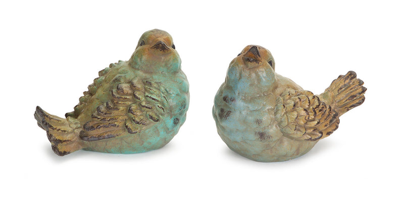Two ceramic bird figurines with a greenish-blue patina on a white background
