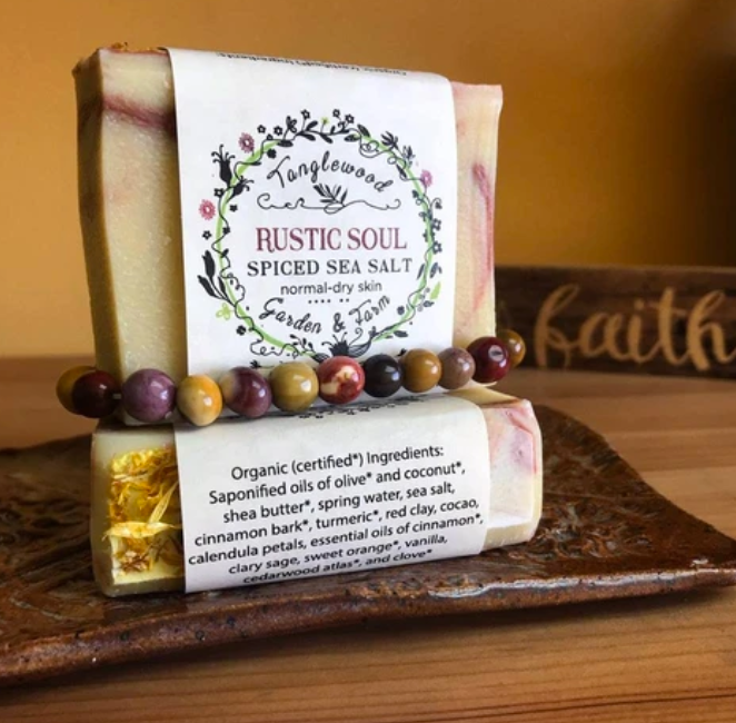 Bar of soap with a label on a wooden surface