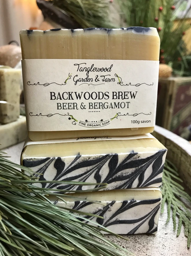 Bar of soap with 'Tanglewood Garden & Farm' branding on a natural background