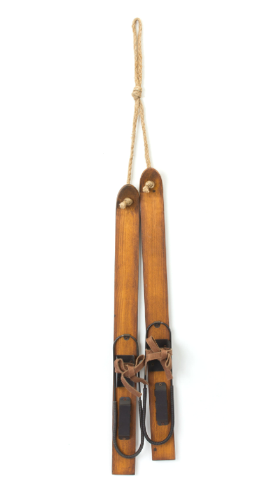 Pair of wooden skis with leather straps on a white background