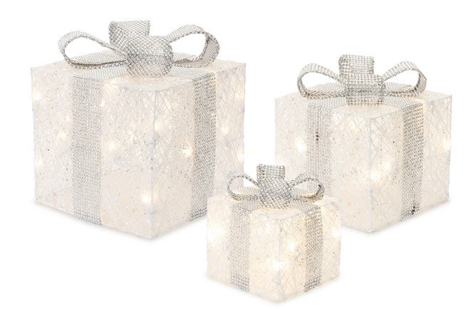 Set of three decorative gift boxes with lights and ribbons on a white background