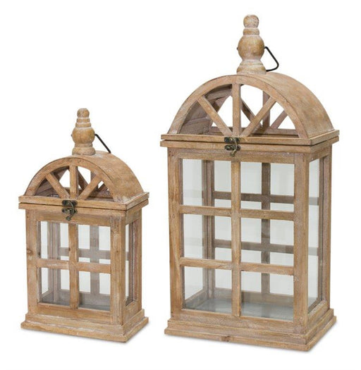 Two wooden lanterns with glass panels on a white background