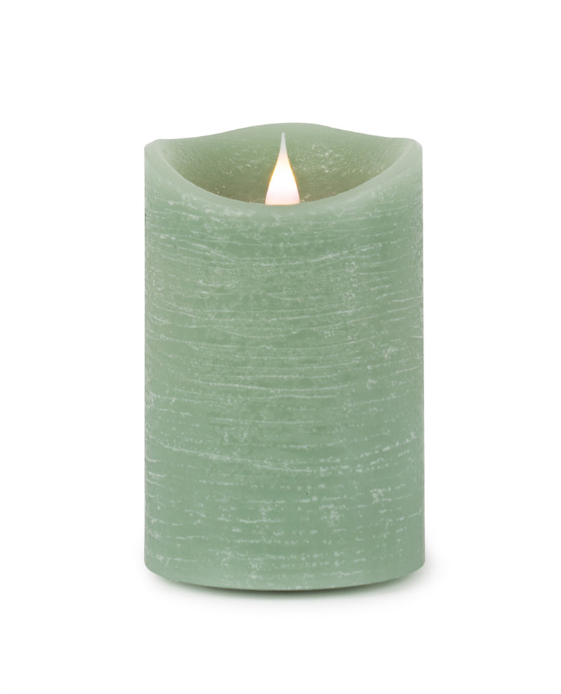 Green candle with a flame on a white background