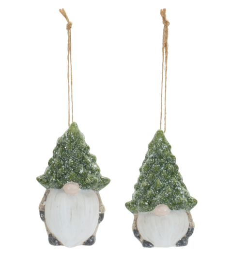Two Christmas-themed gnomes with tree hats hanging on a white background