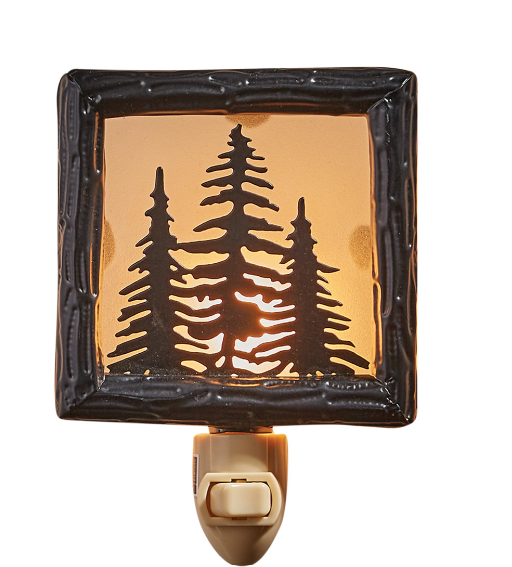 Decorative night light with tree silhouette design on a white background