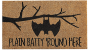 Doormat with bat design and text 'Plain Batty Round Here' on a beige background