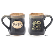 Two black ceramic mugs with a cream rim and interior, one with 'PAPA' text on the front and the other with the phrase 'PAPA THE MAN THE MYTH THE LEGEND' on the reverse.