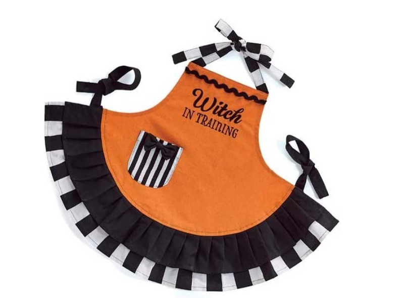 Halloween-themed apron with 'Witch in Training' text on an orange background