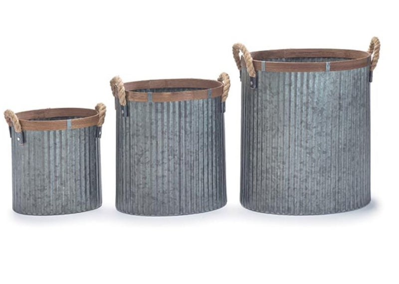 Three metal baskets with brown handles on a white background
