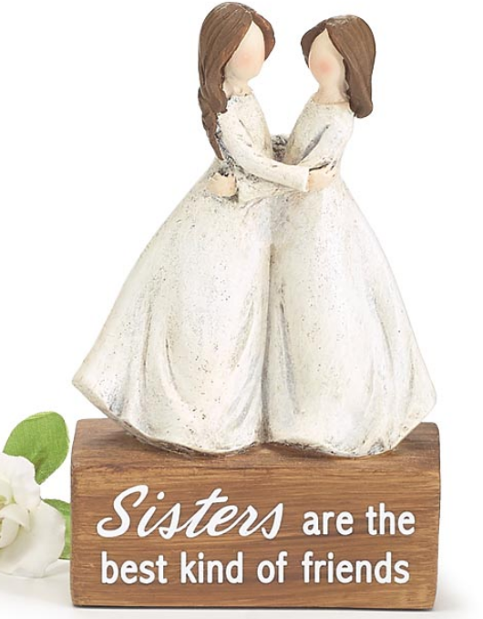 Decorative figurine of two women holding hands with a wooden base and text on a white background