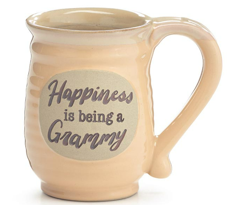 A beige hand-painted porcelain taupe mug with a raised emblem on the front that reads 'Happiness is being a GRAMMY'.