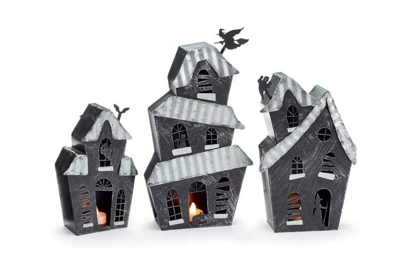Set of three Halloween-themed house-shaped lanterns on a white background