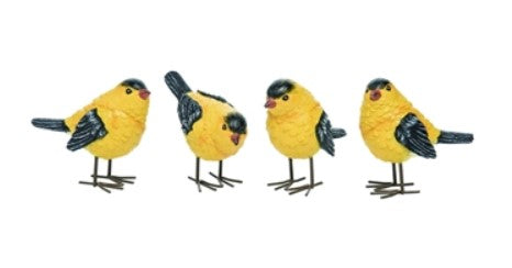 Four yellow bird figurines with black wings on a white background