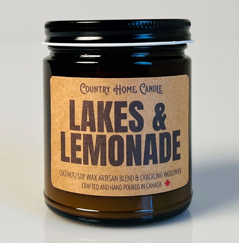Jar of 'Lakes & Lemonade' candle with a brown label on a light gray background