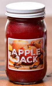 Jar of 'Apple Jack' candle with a label on a wooden surface