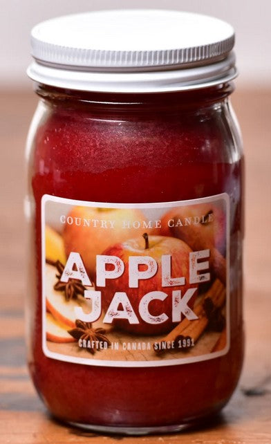 Jar of 'Apple Jack' candle with a label on a wooden surface